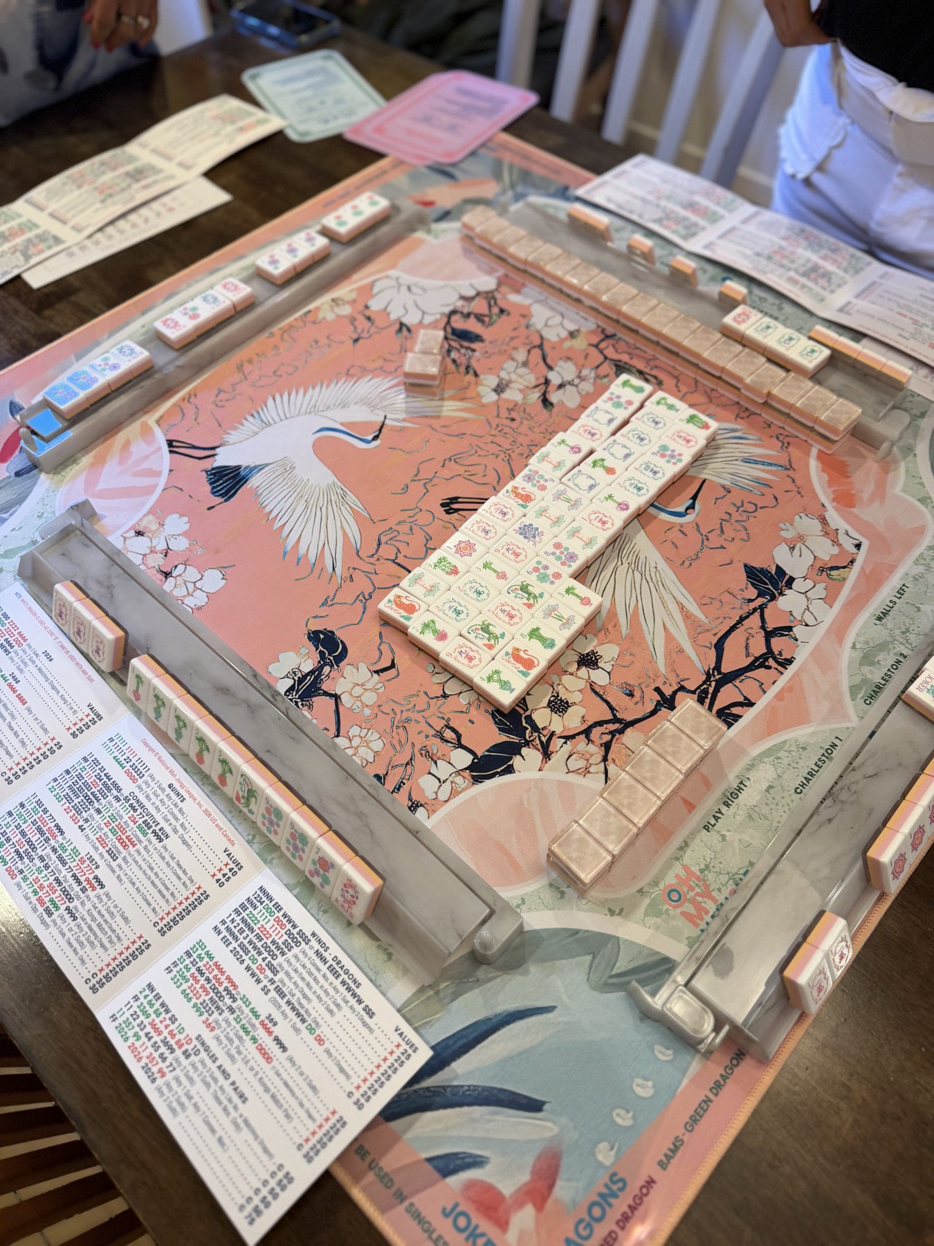A crane-print mat mid-game, racks and tiles in play