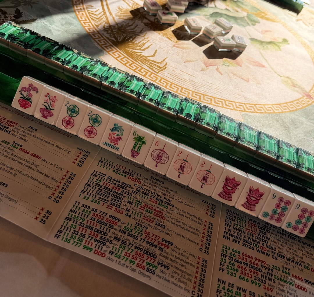 Rows of green racked tiles on a printed mat